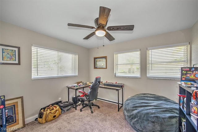 carpeted office space featuring a wealth of natural light and ceiling fan