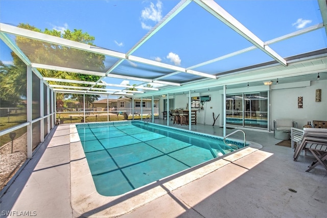 view of pool with a lanai and a patio