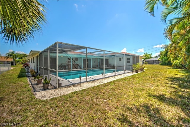 view of pool featuring a lawn and glass enclosure