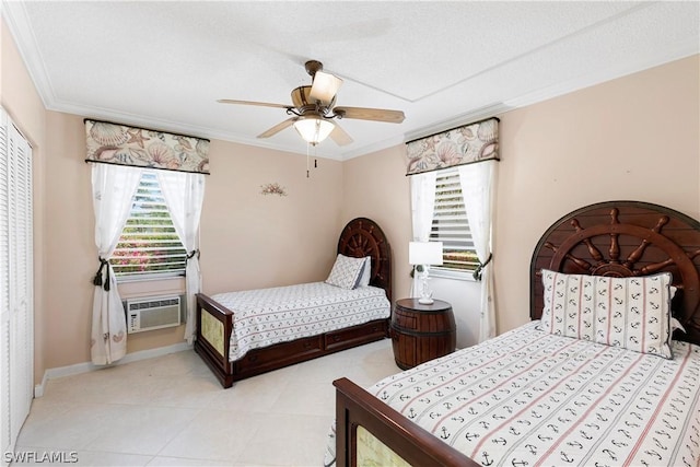 bedroom with ceiling fan, cooling unit, a textured ceiling, a closet, and ornamental molding