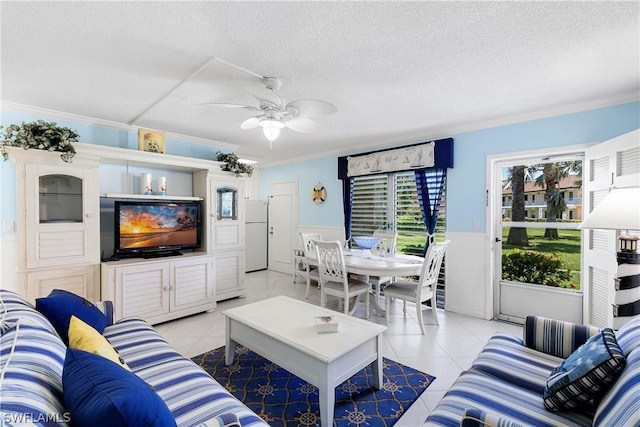 tiled living room with ceiling fan, crown molding, plenty of natural light, and a textured ceiling