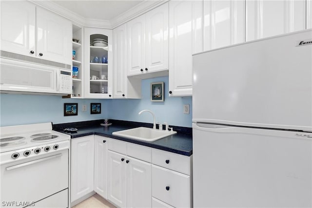 kitchen with white cabinets, white appliances, and sink