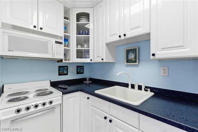 kitchen featuring white cabinetry, sink, and white appliances