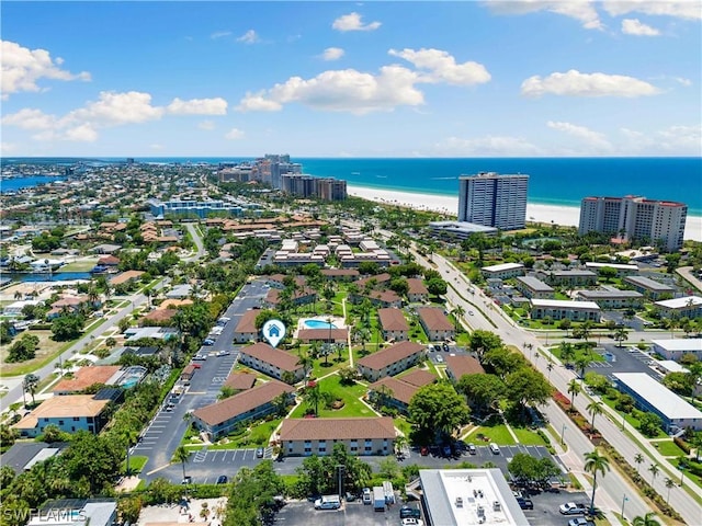 aerial view with a water view and a beach view