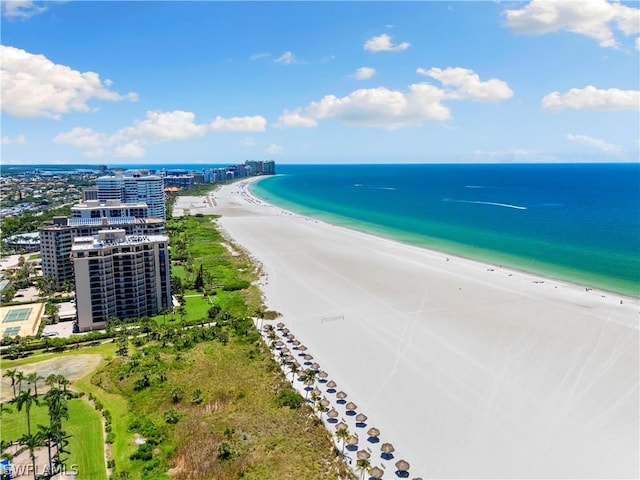 drone / aerial view with a beach view and a water view