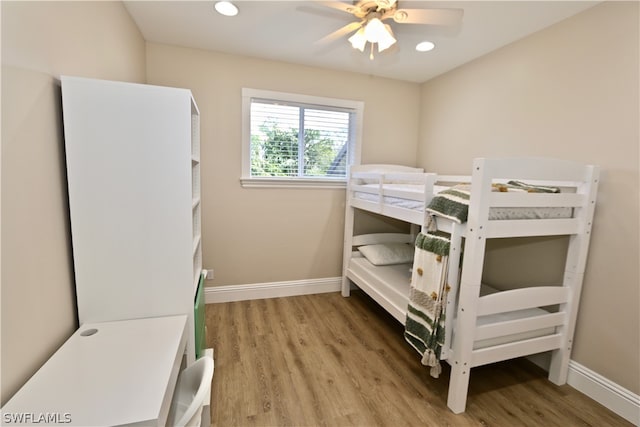 bedroom with ceiling fan and hardwood / wood-style flooring