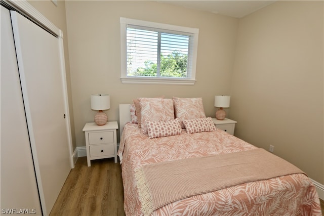 bedroom featuring hardwood / wood-style floors and a closet