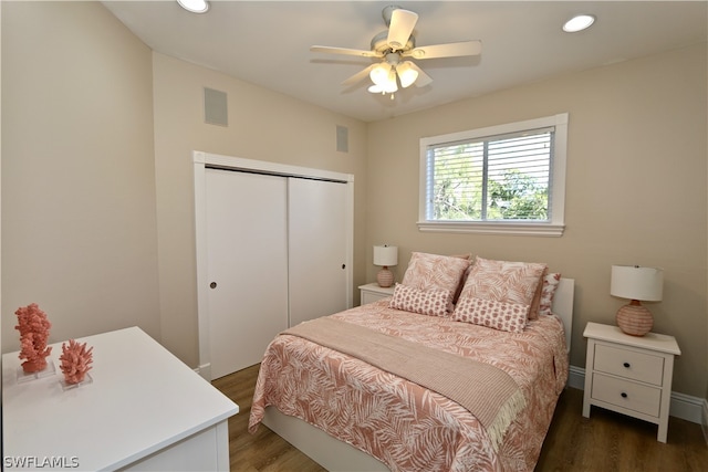 bedroom featuring ceiling fan, a closet, and dark hardwood / wood-style flooring