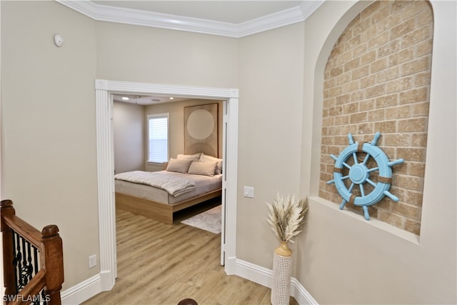 bedroom with ornamental molding and light wood-type flooring