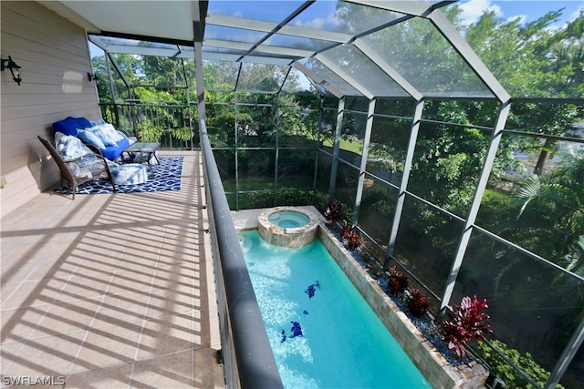 view of swimming pool with a lanai and an in ground hot tub