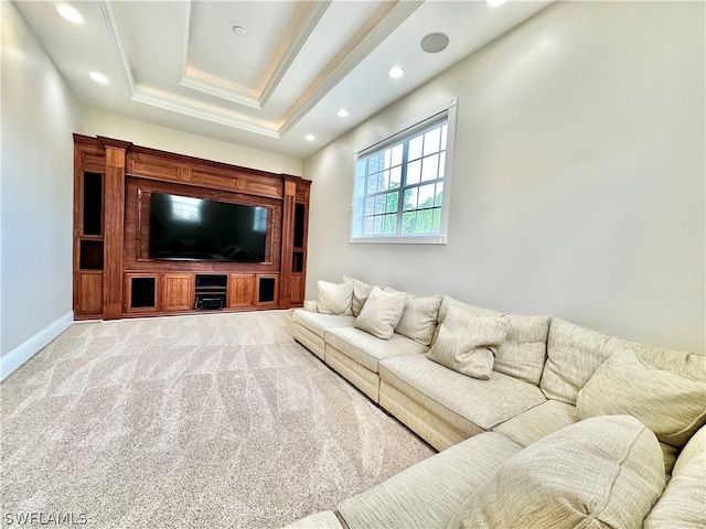 carpeted living room featuring a tray ceiling