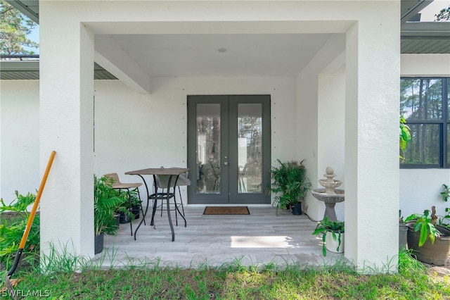 property entrance featuring a patio area and french doors