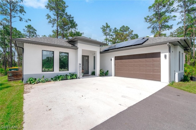 view of front of house with solar panels and a garage