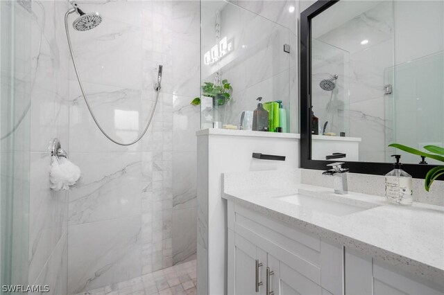 bathroom with vanity and a shower with shower door