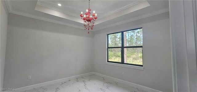 unfurnished room featuring a chandelier, crown molding, and a tray ceiling