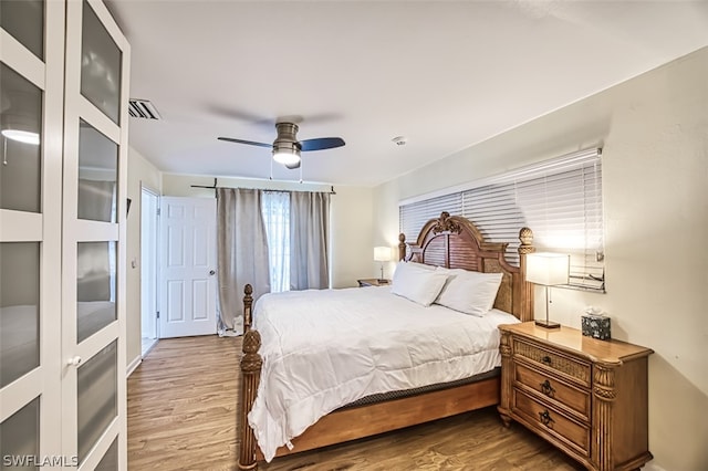 bedroom with ceiling fan and wood-type flooring