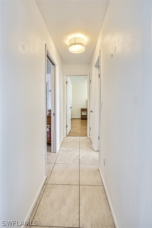 corridor with light tile patterned flooring