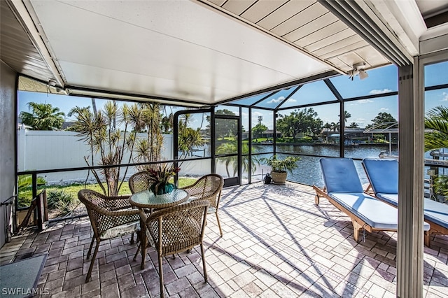 unfurnished sunroom with a water view