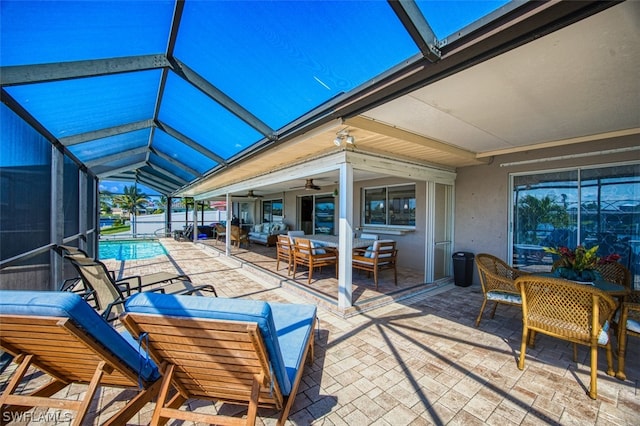 view of patio / terrace with outdoor lounge area, ceiling fan, and a lanai