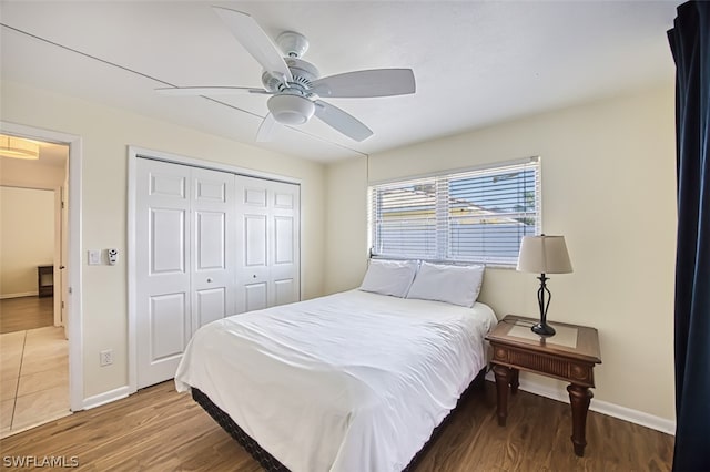 bedroom featuring ceiling fan, a closet, and hardwood / wood-style flooring