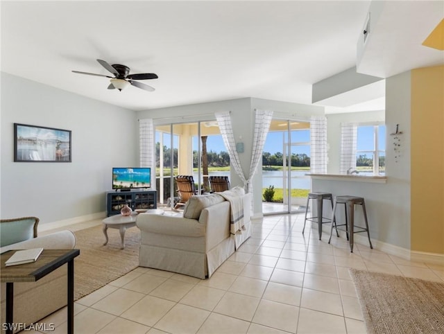 living room featuring ceiling fan and light tile patterned floors