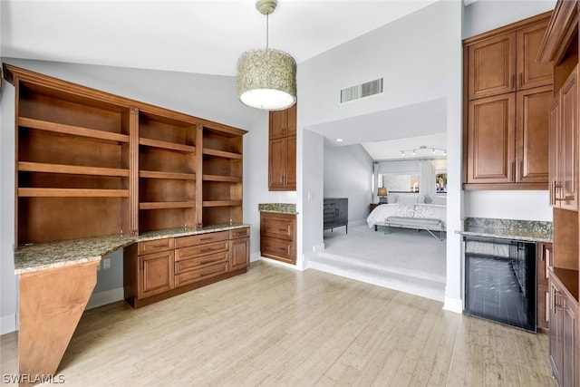 interior space featuring high vaulted ceiling, beverage cooler, and light wood-type flooring