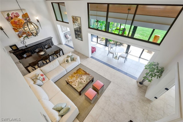 tiled living room featuring a high ceiling