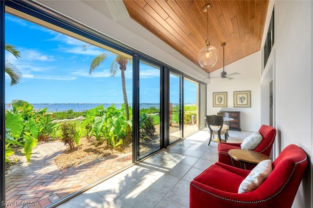 sunroom / solarium featuring ceiling fan, a water view, wood ceiling, and vaulted ceiling