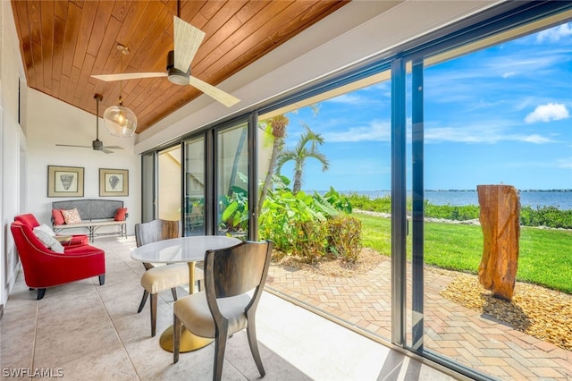 sunroom featuring ceiling fan, a water view, wood ceiling, and vaulted ceiling