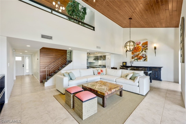 tiled living room featuring wooden ceiling, high vaulted ceiling, and a notable chandelier