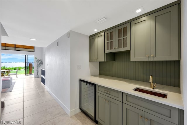 kitchen featuring wine cooler, sink, and light tile patterned flooring