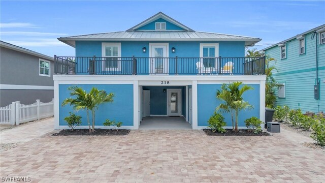 view of front of home with a carport and a balcony