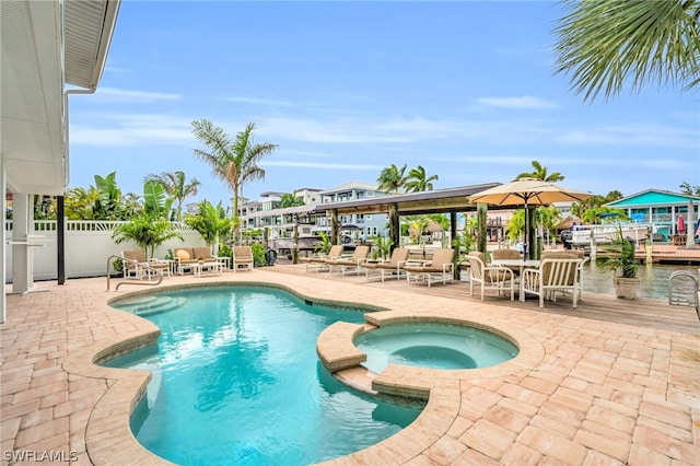 view of swimming pool with a patio area and an in ground hot tub