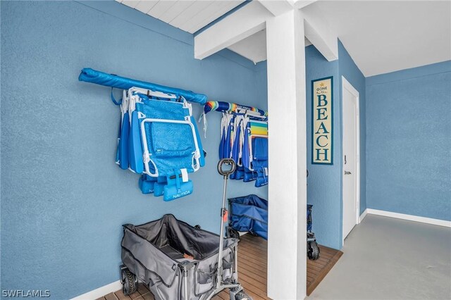 spacious closet featuring beamed ceiling