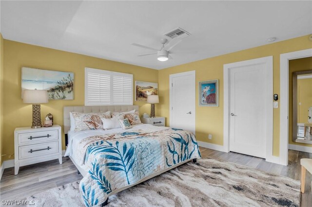 bedroom with light hardwood / wood-style floors and ceiling fan