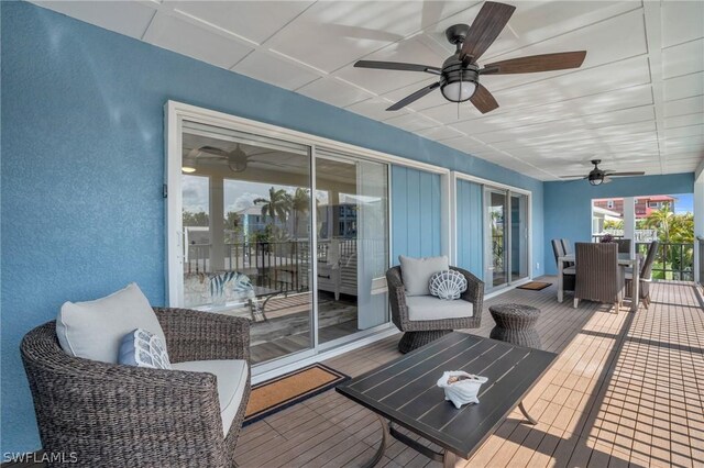 deck featuring outdoor lounge area and ceiling fan