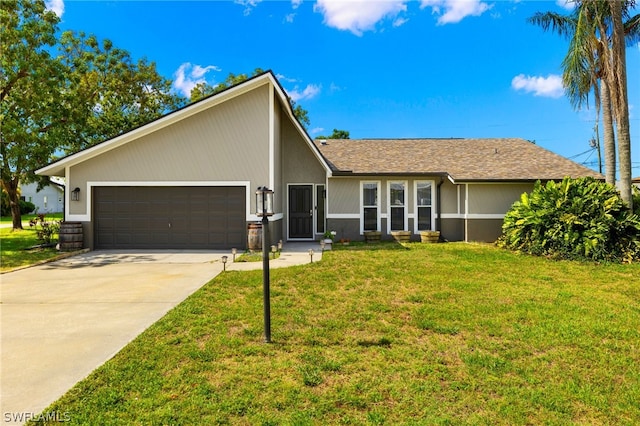 ranch-style house featuring a front lawn and a garage