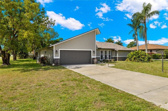 single story home with a front yard and a garage