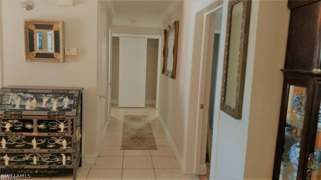 corridor with light tile patterned floors and ornamental molding