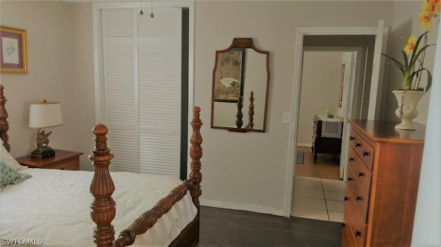 bedroom featuring dark tile patterned flooring and a closet