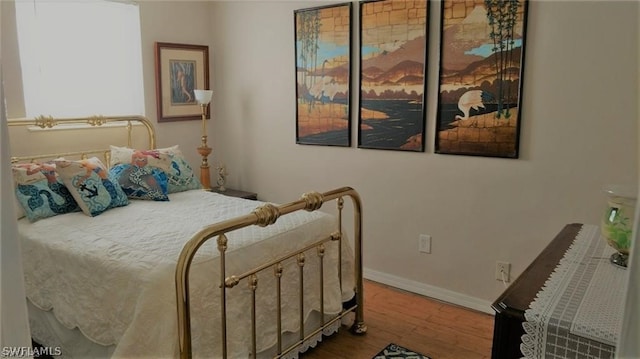 bedroom with wood-type flooring