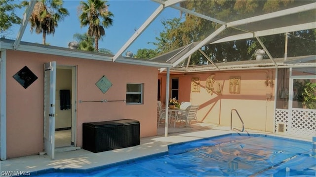 view of swimming pool with a patio and a lanai