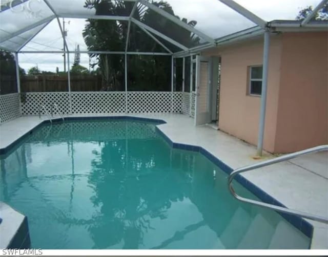 view of swimming pool with a lanai