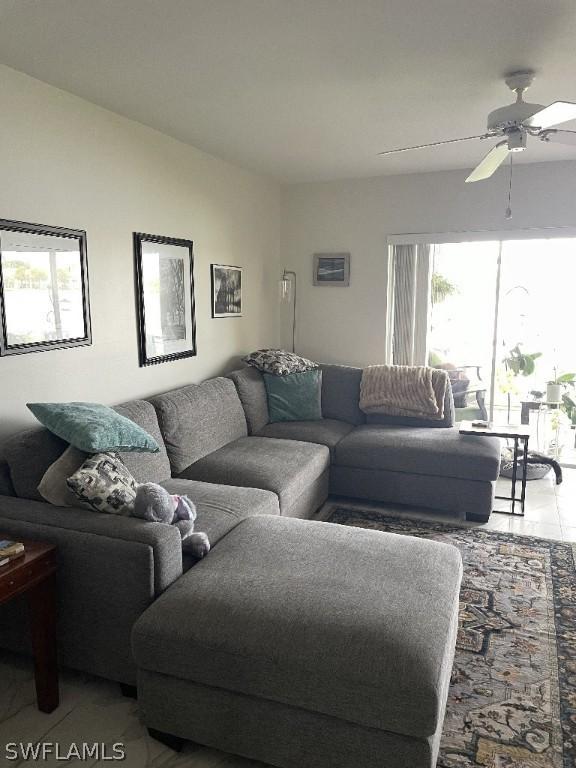 tiled living room with ceiling fan