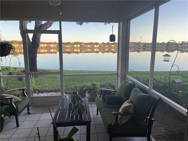 sunroom featuring a water view and a wealth of natural light