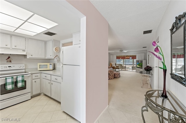 kitchen featuring white cabinetry, light carpet, ceiling fan, and white appliances