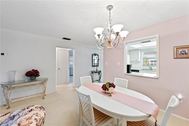 carpeted dining room featuring a textured ceiling, an inviting chandelier, and sink