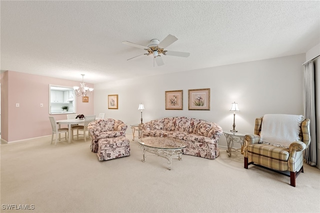 living room with ceiling fan with notable chandelier, carpet floors, and a textured ceiling