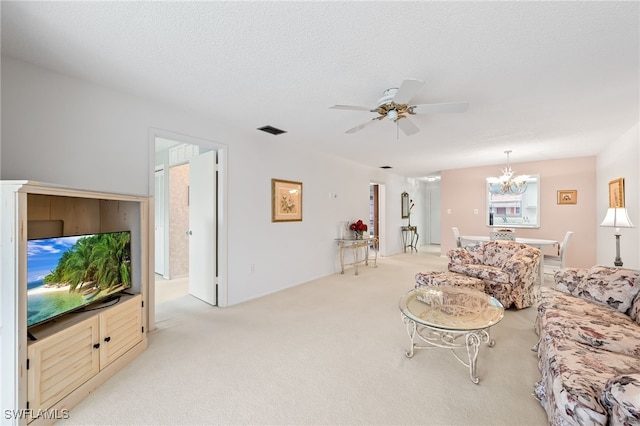 carpeted living room featuring ceiling fan with notable chandelier and a textured ceiling