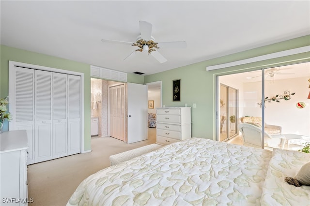 bedroom with ceiling fan, light colored carpet, and ensuite bathroom